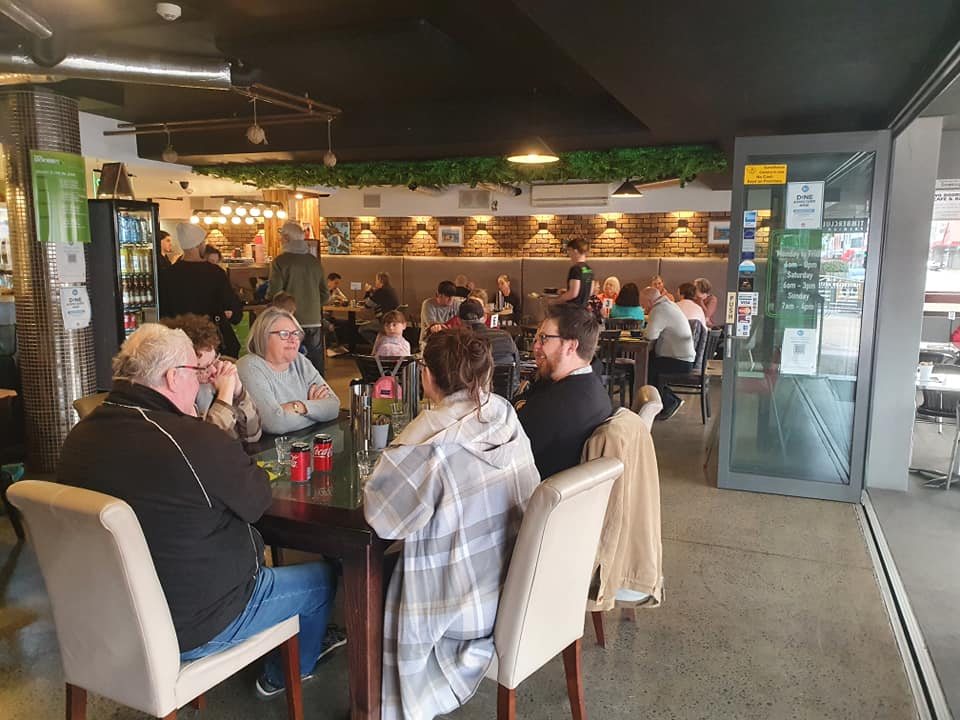 The dining room, with guests at tables and the counter in the background